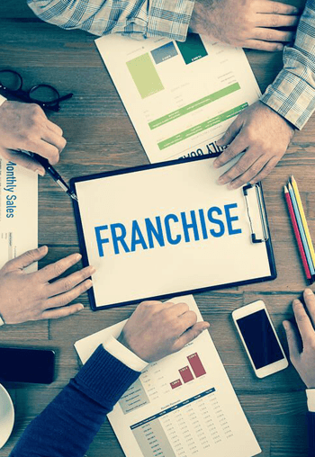 Franchise business meeting with documents and charts